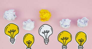 knowledge management light bulbs with crumpled paper