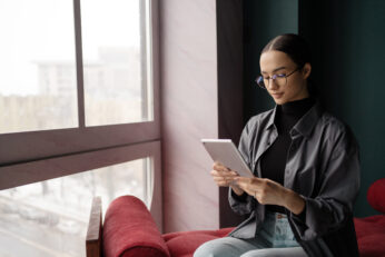 woman using tablet to reduce support tickets