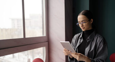 woman using tablet to reduce support tickets